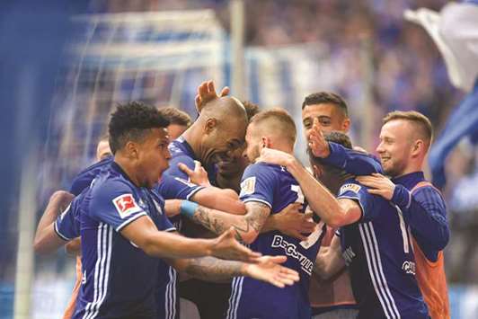 Schalkeu2019s Naldo (second left) celebrates with teammates after scoring during the Bundesliga match against Borussia Dortmund. (AFP)