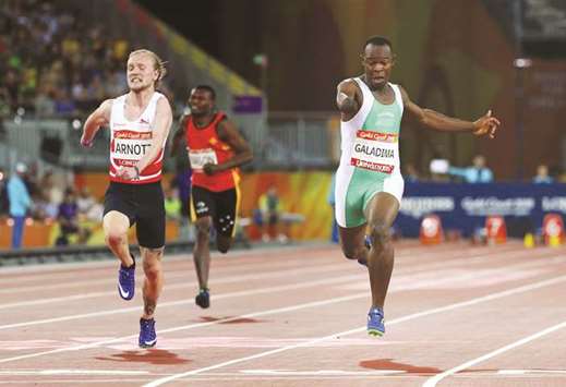 Suwaibidu Galadima (right) of Nigeria and James Arnott (left) of England in action during the menu2019s T47 100m final in Gold Coast, Australia, on Friday. (Reuters)