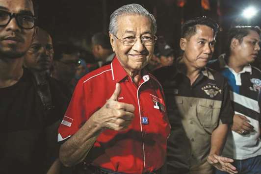 Former Malaysian prime minister Mahathir Mohamed gestures as he arrives for a rally ahead of the 14th general election on the island of Langkawi, yesterday.