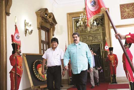 Venezuelau2019s President Nicolas Maduro walks next to Boliviau2019s President Evo Morales during their meeting in Caracas, Venezuela, yesterday.
