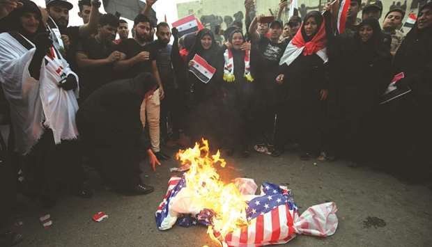 Iraqi protesters burn a US flag during a demonstration in Baghdad yesterday, opposing the joint Western air strikes against Syriau2019s regime.
