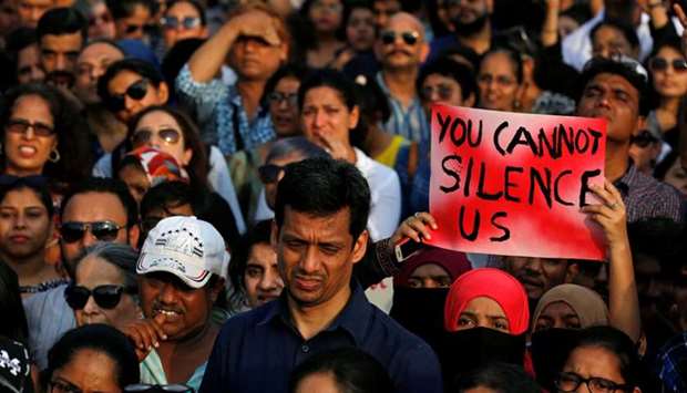 A woman holds a placard as she participates in a protest against the rape of an eight-year-old girl in Kathua near Jammu, and a teenager in Unnao, Uttar Pradesh state, in Mumbai, India.