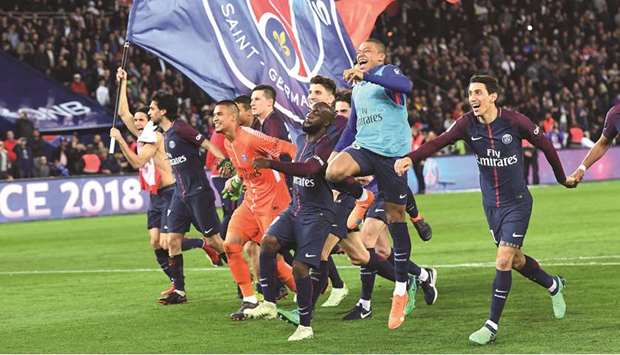 Paris Saint-Germain players celebrate their win over Monaco and their Ligue 1 title victory at the Parc des Princes stadium in Paris on Sunday. (AFP)