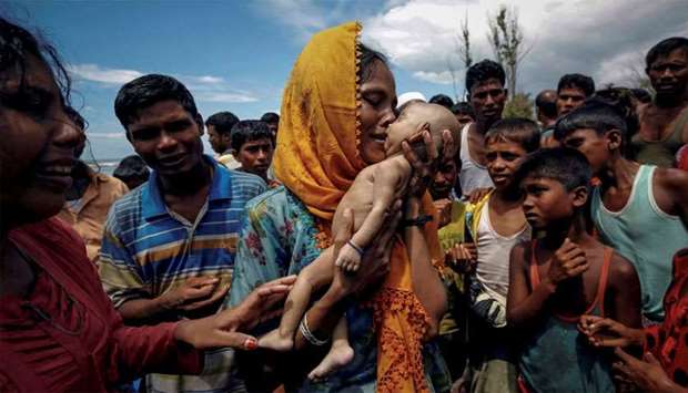 Hamida, a Rohingya refugee woman, weeps as she holds her 40-day-old son after he died as their boat capsized before arriving on shore in Shah Porir Dwip, Teknaf, Bangladesh, September 14, 2017. Reuters won Pulitzer for Feature Photography for this picture.