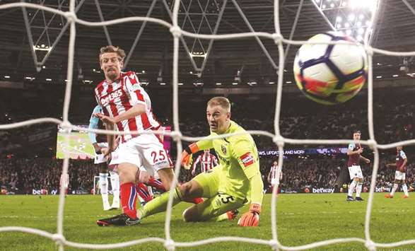 Stoke Cityu2019s Peter Crouch scores a goal against West Ham Unitedu2019s goal-keeper Joe Hart during their EPL match. (Reuters)