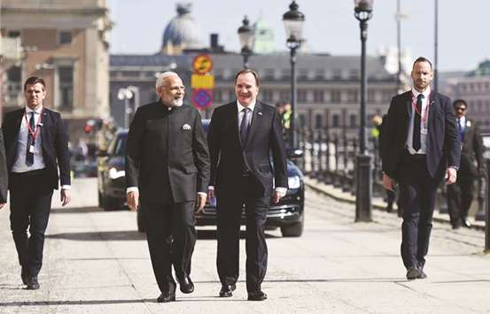 Prime Minister Narendra Modi takes a short walk with his Swedish counterpart Stefan Lofven from Sager House to Rosenbad, in Stockholm yesterday.