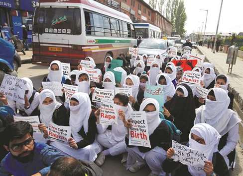 Schoolgirls holding placards sit in a road during a protest against the rape of an eight-year-old girl in Kathua, near Jammu, a teenager in Unnao, Uttar Pradesh, and an 11-year-old girl in Surat, in Srinagar yesterday.