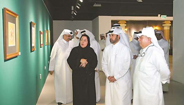 Dignitaries touring the exhibition with the artist.