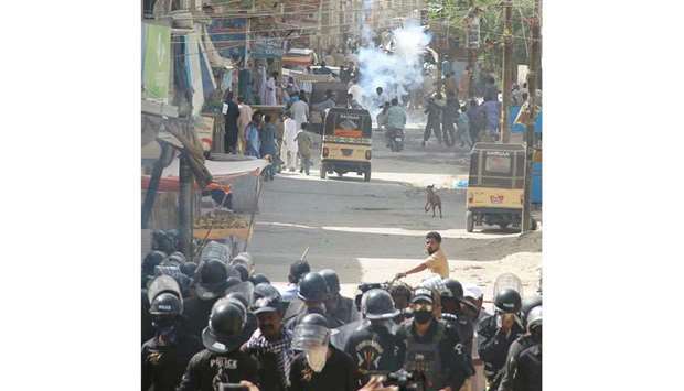 Police personnel are seen during a protest in Karachi over the rape and murder of a six-year-old girl.