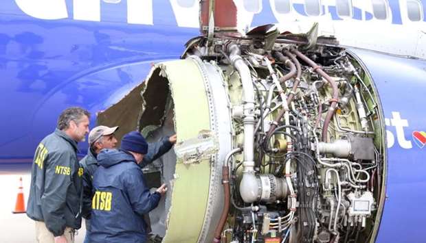 US NTSB investigators are on scene examining damage to the engine of the Southwest Airlines plane in this image released from Philadelphia, Pennsylvania, US