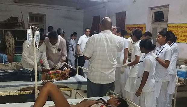 Indian accident survivors receive medical care at Sidhi's Civil hospital on April 18, 2018, after a truck carrying wedding revellers plunged late on April 17, when crossing Jogdha bridge over Son river, some 50kms from Sidhi town in Singrauli district of Madhya Pradesh state.