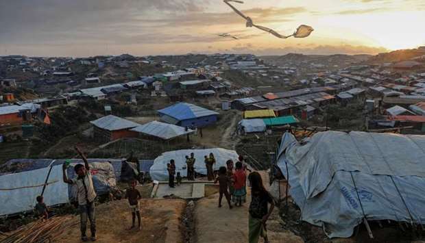 Rohingya refugee children fly improvised kites at the Kutupalong refugee camp near Cox's Bazar, Bangladesh