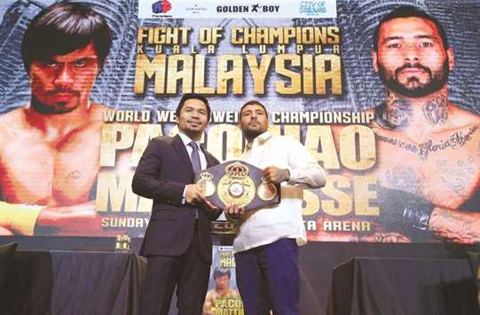Philippine Senator and boxing icon Manny Pacquiao (left) poses with welterweight world title holder Lucas Matthysse for their upcoming WBA u2018regularu2019 welterweight title fight in Kuala Lumpur, during a news conference in a hotel in Manila yesterday. (Reuters)