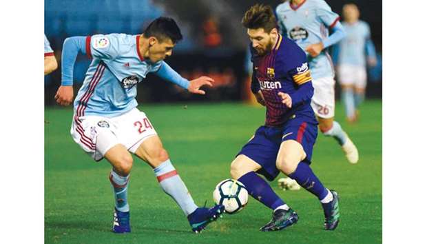 Barcelonau2019s Lionel Messi (right) vies for the ball with Celta Vigou2019s Facundo Roncaglia during the Spanish La Liga match on Tuesday night. (AFP)