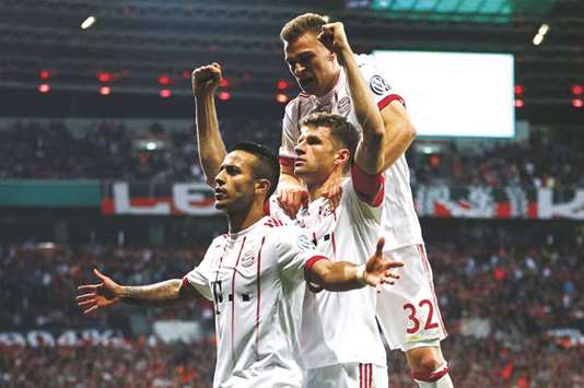 Bayern Munichu2019s Thiago Alcantara (left) celebrates with teammates after scoring against Bayer Leverkusen on Tuesday. (Reuters)