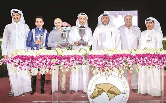 Hamad Mohamed al-Khayareen (third from right) and Qatar Racing and Equestrian Club (QREC) deputy chief steward Abdulla Rashid al-Kubaisi (right) with the winners of the Al Wakra Cup after Sheikh Khalifa bin Mohamed bin Khalifa al-Thaniu2019s Ishfaq won the 1900m race at the QREC yesterday. PICTURES: Juhaim