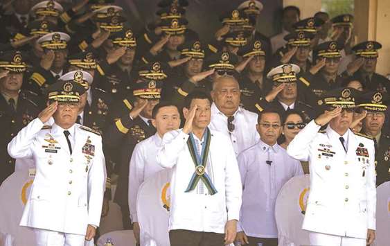 Outgoing Armed Forces of the Philippines chief of staff Rey Leonardo Guerrero (left) salutes to the flag alongside President Rodrigo Duterte and incoming AFP chief of staff Carlito Galvez (right) during the Armed Forces of the Philippines change of command ceremony at the AFP headquarters in Camp Aguinaldo in Manila, yesterday.