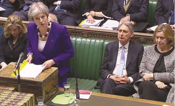 Prime Minister Theresa May speaks as Home Secretary Amber Rudd listens, during the weekly Prime Ministeru2019s Questions (PMQs) in the House of Commons in central London yesterday. May on Tuesday personally apologised to Caribbean leaders after her government threatened to deport some of the hundreds of thousands of people who emigrated to Britain from the region in the 1950s and 1960s.
