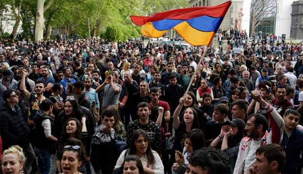 Armenians wave the national flag during an opposition rally in central Yerevan