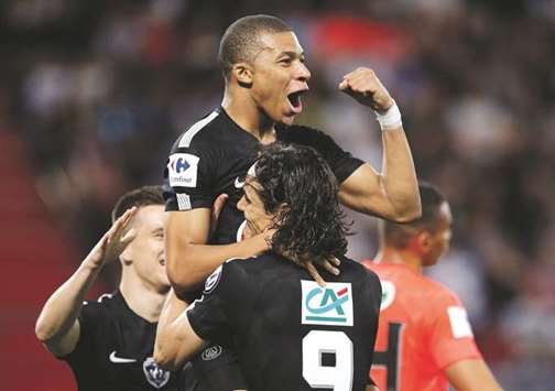 Paris Saint-Germainu2019s Kylian Mbappe celebrates with Edinson Cavani after scoring against Caen in the French Cup semi-final on Wednesday night. (Reuters)