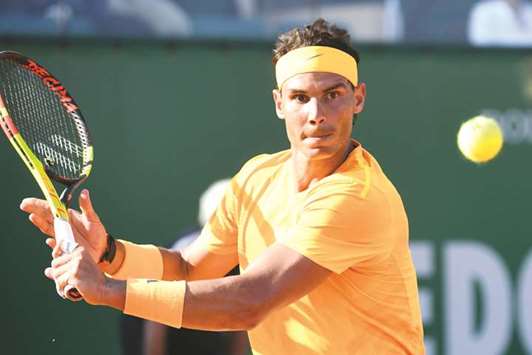 Spainu2019s Rafael Nadal hits a return to Russiau2019s Karen Khachanov during their match at the Monte-Carlo ATP Masters in Monaco yesterday. (AFP)