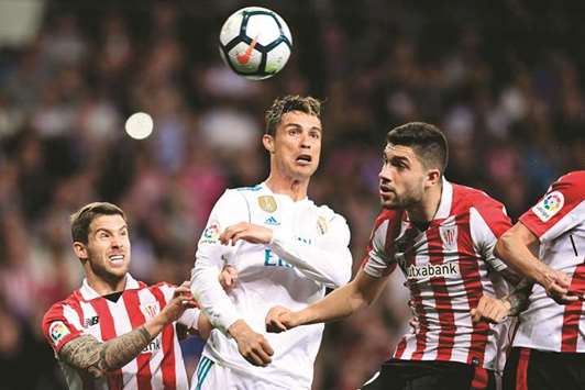 Athletic Bilbaou2019s Inigo Martinez (left) and Unai Nunez (right) vie for the ball with Real Madridu2019s Cristiano Ronaldo during the Spanish La Liga match in Madrid. (AFP)