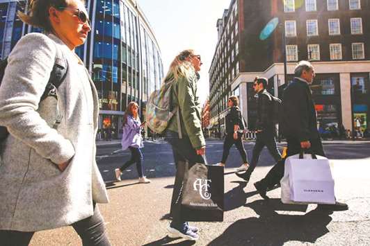 Shoppers carry shopping bags along Oxford Street in London. Unusually cold and snowy weather caused retail sales volumes to drop by 1.2% compared with the month before, the UKu2019s Office for National Statistics said, a bigger fall than most economists polled by Reuters had expected.