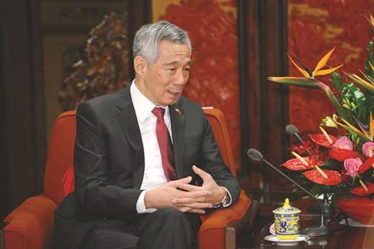 Singaporeu2019s Prime Minister Lee Hsien Loong speaks at a press conference in Beijing. Lee said even wide-ranging trade initiatives such as the Trans-Pacific Partnership and Regional Comprehensive Economic Partnership would not compensate for the damage caused by a trade war for most countries in the Asia-Pacific region.