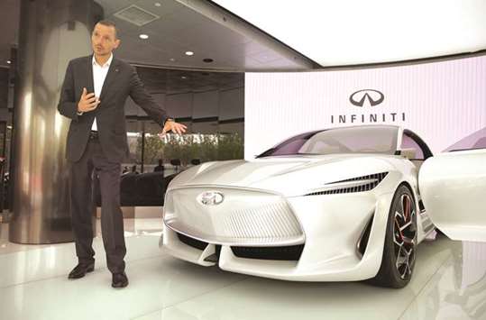 Roland Kruger, president of Nissanu2019s Infiniti Motor Company, speaks next to an Infiniti Q Inspiration concept car at a flagship showroom in Beijing. Infiniti aims to boost sales in China to roughly 150,000 vehicles a year, up from 48,000 last year, Krueger said in an interview in Beijing.