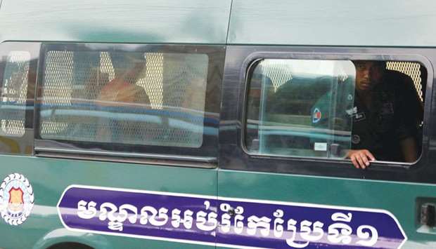 Uon Chhin and Yeang Sothearin, former journalists of the Radio Free Asia (RFA), inside a police vehicle as they arrive for a bail hearing at the Appeal Court in Phnom Penh, Cambodia.