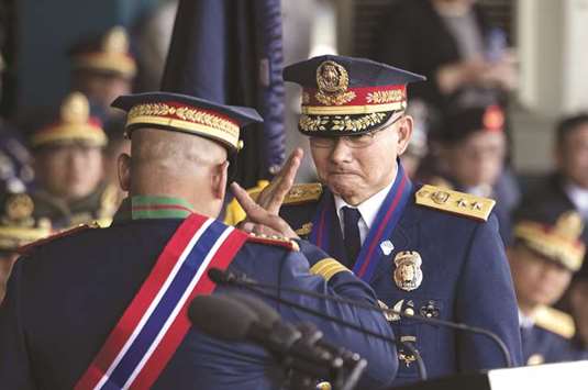 Outgoing Philippine National Police (PNP) chief Ronald dela Rosa (left) salutes incoming PNP chief Oscar Albayalde during the change of command ceremony at Camp Crame in Manila yesterday.