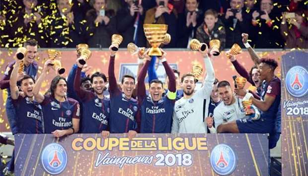 Paris Saint-Germain's Brazilian defender Thiago Silva (centre) holds the trophy as he celebrates with teammates after victory in the French League Cup final in Bordeaux on Saturday.
