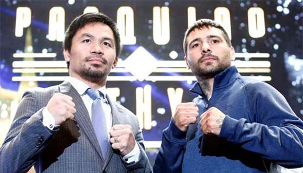 Manny Pacquiao and Lucas Matthysse pose for photographers during a news conference in Kuala Lumpur on Friday.
