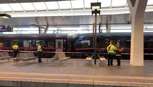 Emergency responders are seen on a platform following a train crash in Salzburg on Friday.