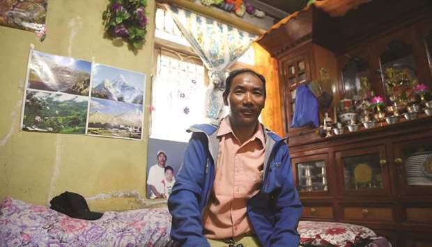Kami Rita Sherpa sitting in his rented room at Boudhanath Stupa, on the outskirts of Kathmandu.