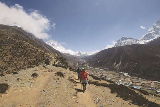Trekkers walk along a path at the Mount Everest region, some 140km northeast of Kathmandu, yesterday. The route is a busy gateway for tourists, climbers and porters heading to the Everest region in Nepal.