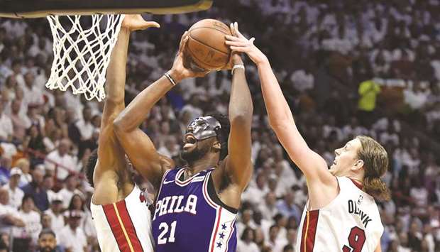 Joel Embiid (centre) of the Philadelphia 76ers drives to the basket against Miami Heat during the second quarter of the game in Miami, Florida.  (AFP)