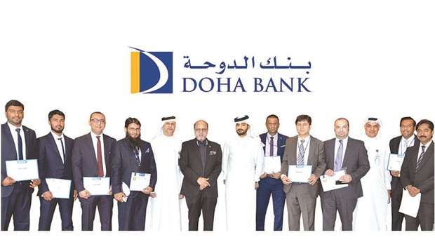 Doha Bank CEO Dr R Seetharaman and other senior officials with the awardees during the ceremony.