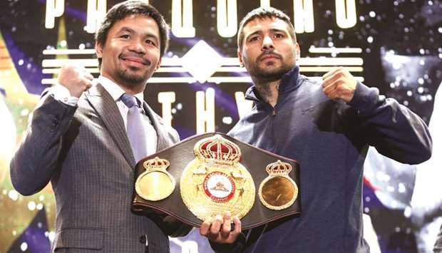 Philippine boxing icon Manny u2018Pacmanu2019 Pacquiao and welterweight world title holder Lucas Matthysse pose during a news conference for their upcoming WBA regular welterweight title fight in Kuala Lumpur, Malaysia, yesterday. (Reuters)