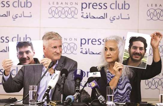 File photo shows Marc (left) and Debra Tice, parents of US journalist Austin Tice who was kidnapped in Syria five years prior, holding respective dated portraits of him during a press conference in Beirut.
