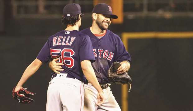 Boston Red Sox first baseman Mitch Moreland hugs relief pitcher Joe Kelly after a win against the Oakland Athletics at Oakland Coliseum in Oakland. PICTURE: USA TODAY Sports