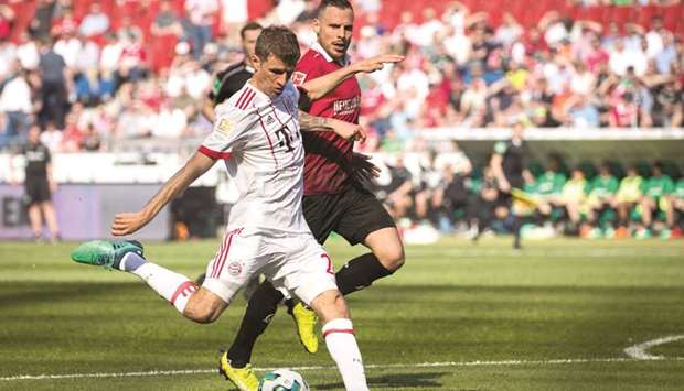 Bayern Munichu2019s Thomas Mueller (left) scores against Hannover 96 during the Bundesliga match yesterday. (AFP)