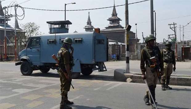 Indian paramilitary troopers patrols infront of a Jamia Masjid during a one day strike called by Kashmiri seperatists against killings in downtown Srinagar on April 2, 2018.