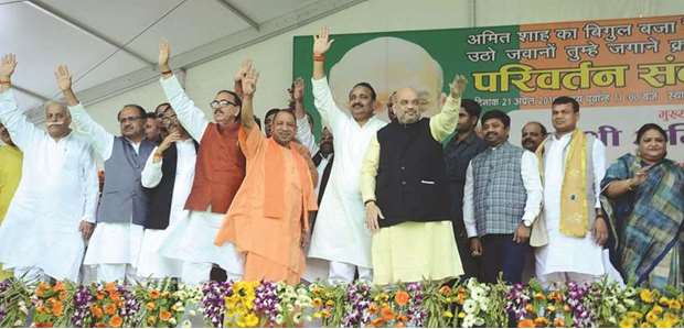 BJP chief Amit Shah, Uttar Pradesh Chief Minister Yogi Adityanath, and other party leaders wave to supporters at a public rally in Rae Bareli yesterday.