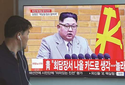 A man watches a television news showing a footage of Kim Jong-un, at a railway station in Seoul.