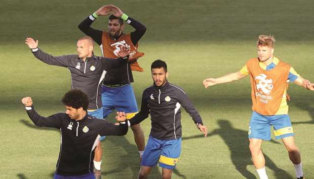 Al Gharafau2019s Portuguese midfielder Diogo Amado (right) takes part in a training session with teammates.