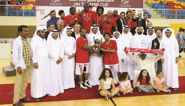 Al Arabi players celebrate their Emir Cup basketball win with the winnersu2019 trophy and the officials at the Al Gharafa Sports Club yesterday.