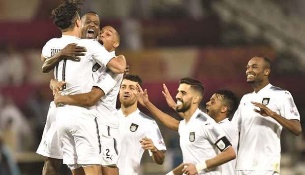 Al Sadd players celebrate their victory over Al Rayyan after the penalty shootout in the Qatar Cup semi-final match at Al Sadd Stadium yesterday.