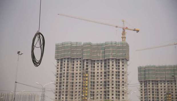 A cable is seen near residential buildings under construction in Beijing. Chinau2019s property loans, mainly individual mortgages and loans for real estate development,  accounted for 38.8% of all new loans made in the first quarter, Reuters calculated from the Peopleu2019s Bank of China data.