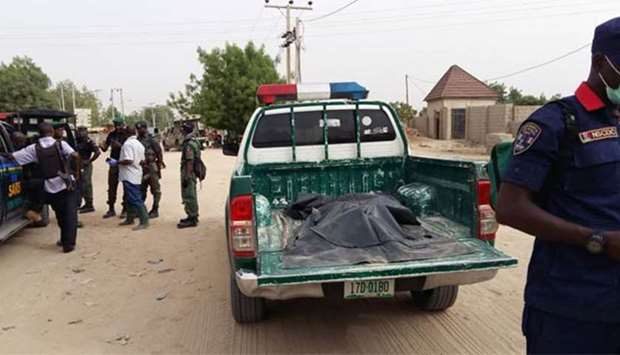 Security forces stand near the site of a suspected Boko Haram attack on the edge of Maiduguri's inner city on Monday.